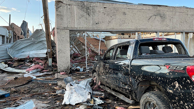 Buildings and a vehicle bear damage from a tornado in Perryton, Texas, Thursday, June 15, 2023. (Alex Driggars/Lubbock Avalanche-Journal via AP)