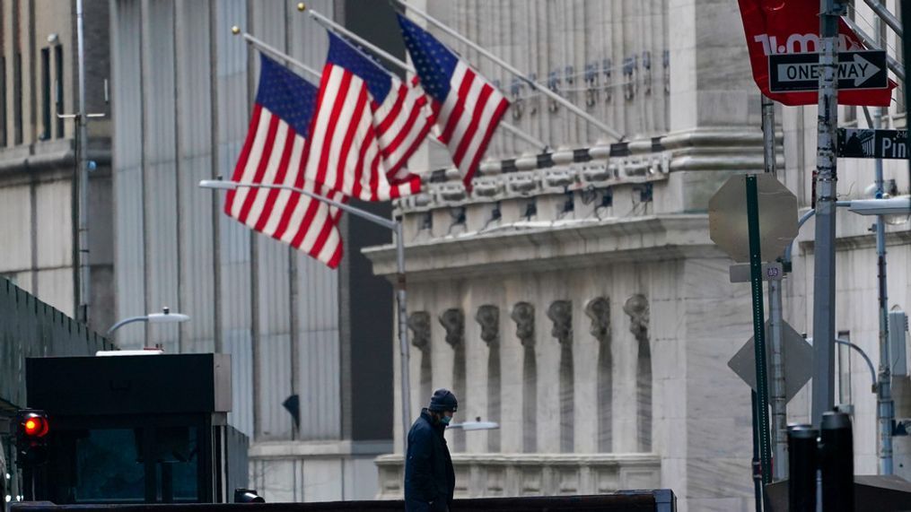 FILE - A security guard is seen next to a road block near the New York Stock exchange, Friday, Jan. 14, 2022, in the Financial District.  (AP Photo/Mary Altaffer, File)