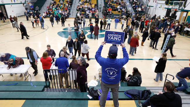 A supporter for Democratic presidential candidate businessman Andrew Yang waits in the stands before a Democratic caucus at Hoover High School, Monday, Feb. 3, 2020, in Des Moines, Iowa. (AP Photo/Charlie Neibergall)
