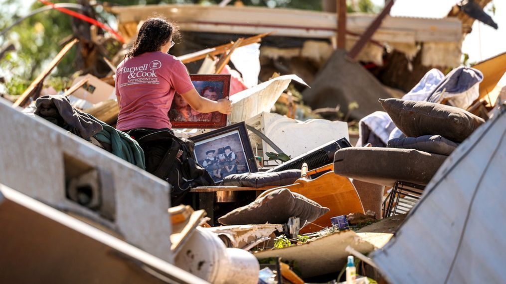 Mariana Valenzuela sifts through the tornado damaged home of her aunt and cousins in Perryton, Texas, Friday, June, 16, 2023. (AP Photo/David Erickson)